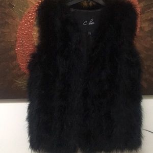 Black authentic fur vest w/ 3 clips to close.